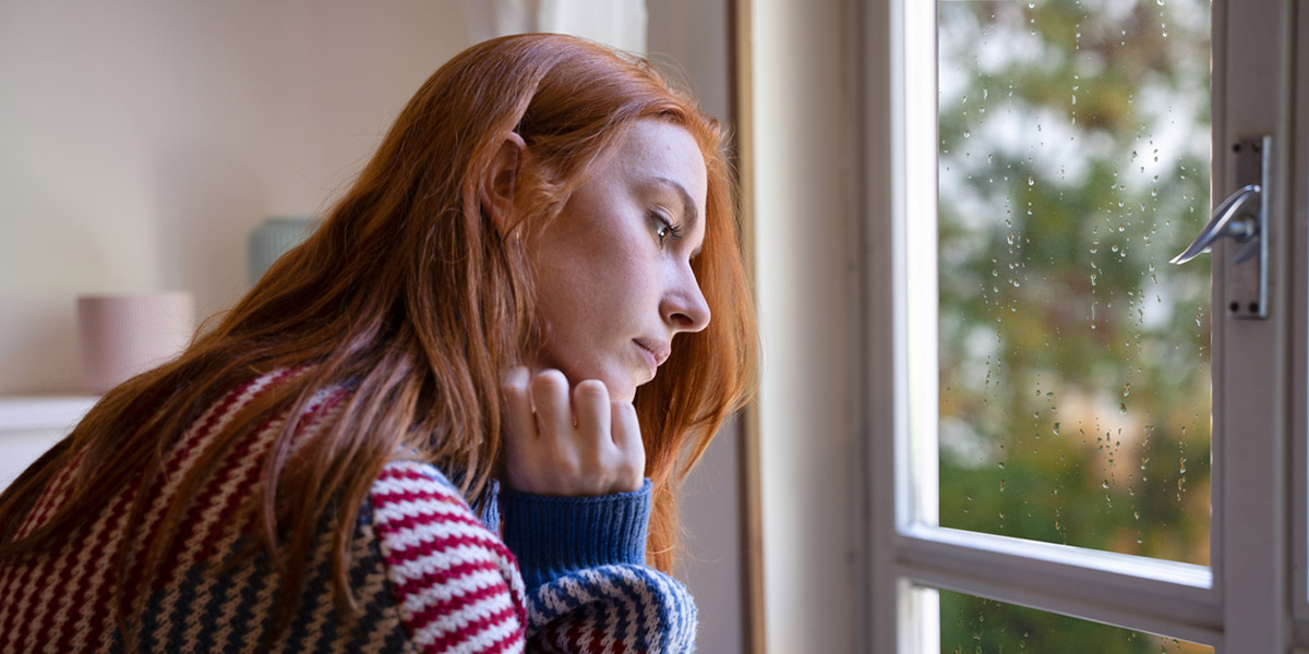 woman with depression at window