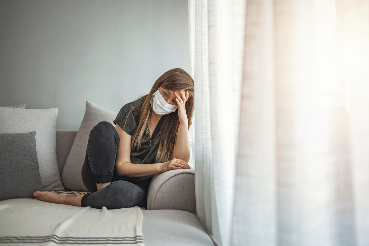 lonely woman wearing mask during pandemic