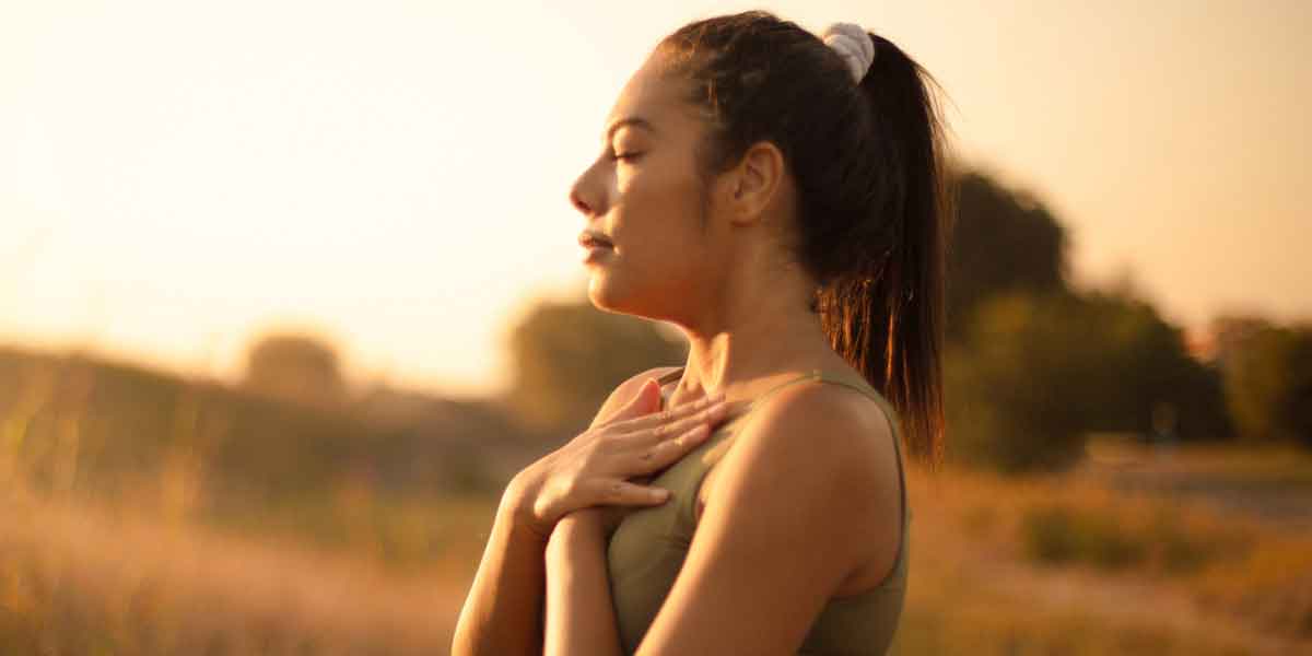 woman with hands on heart calming emotions