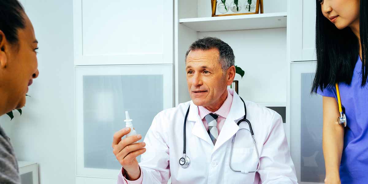 doctor showing patient nasal ketamine treatment