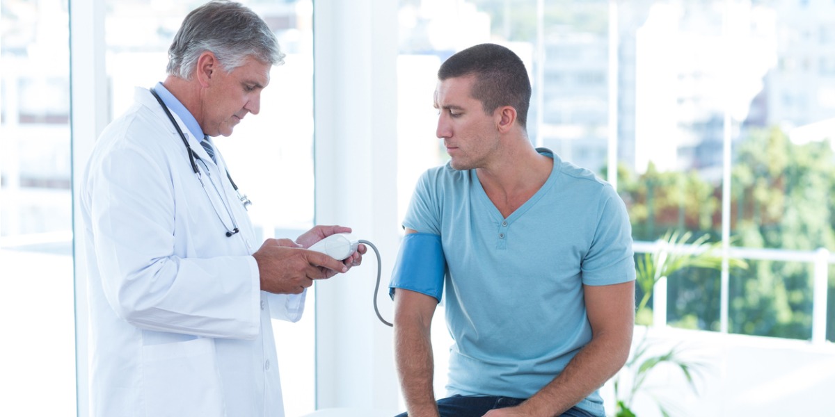 doctor examining male patient