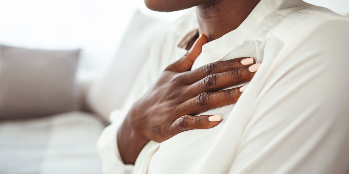 woman holding hand on chest to show anxiety