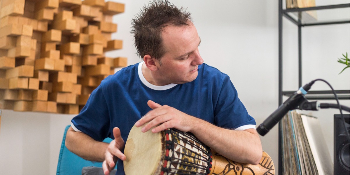 man drumming for music therapy