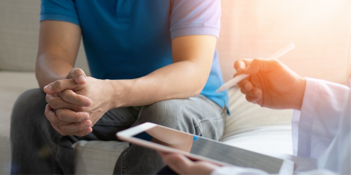 man sitting with therapist for depression testing