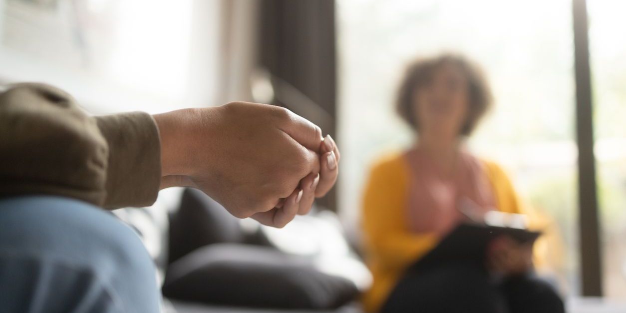 person sitting in psychotherapy session