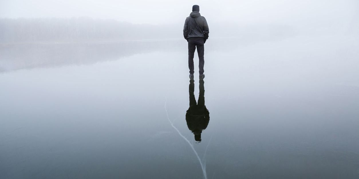 man standing on cracked ice to represent suicide risk