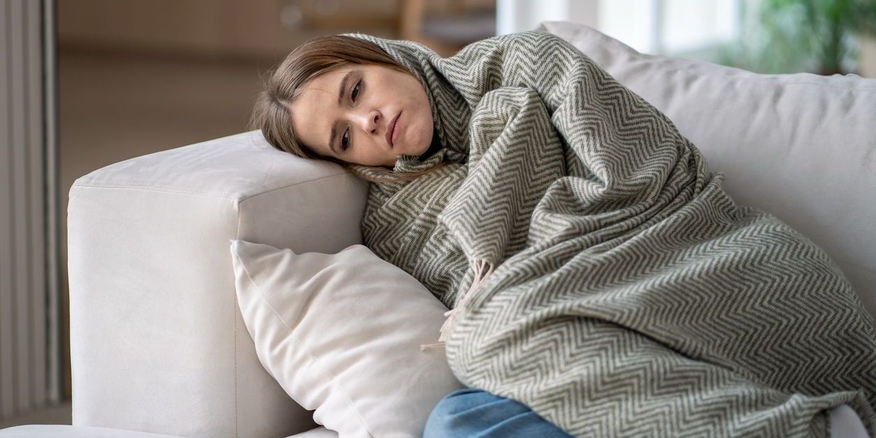 woman with depression lying on the couch